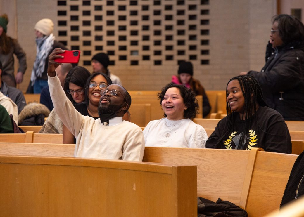 Man taking a photo in the chapel at King Celebration 2024