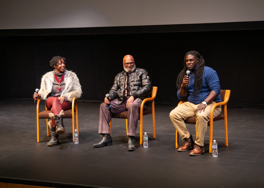 Three men talking on the stage