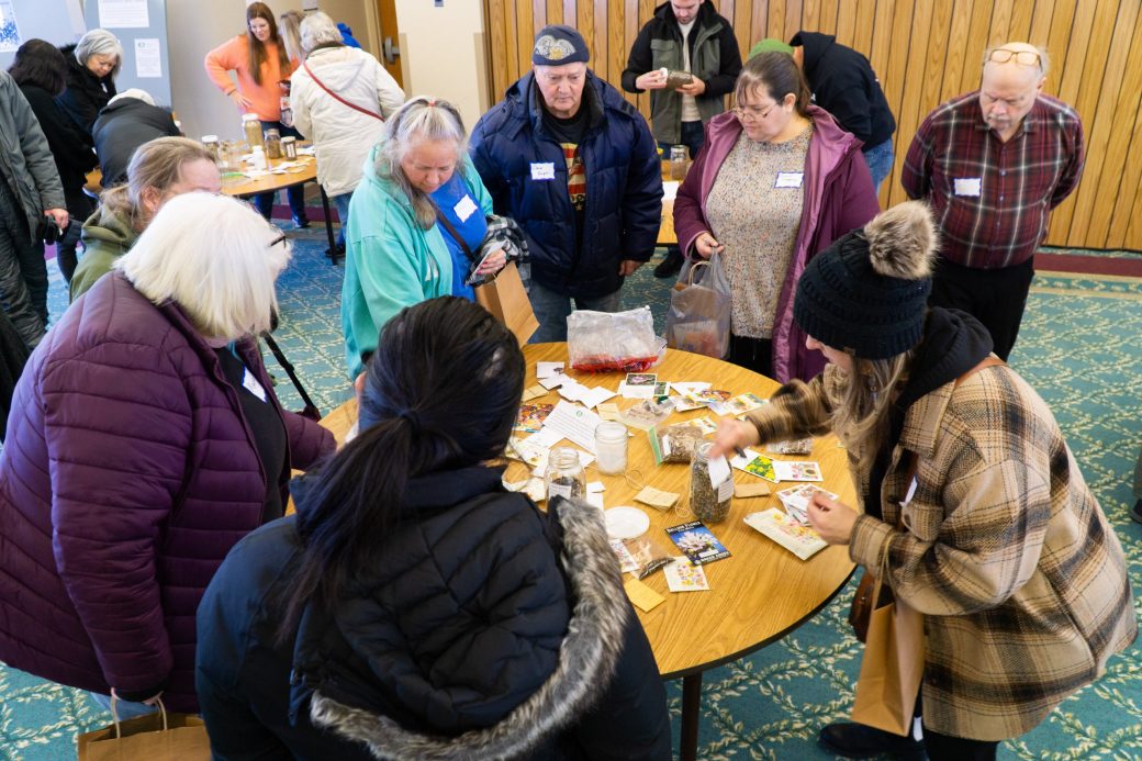People preparing seed packs at Michiana Regional Seed Swap 2024