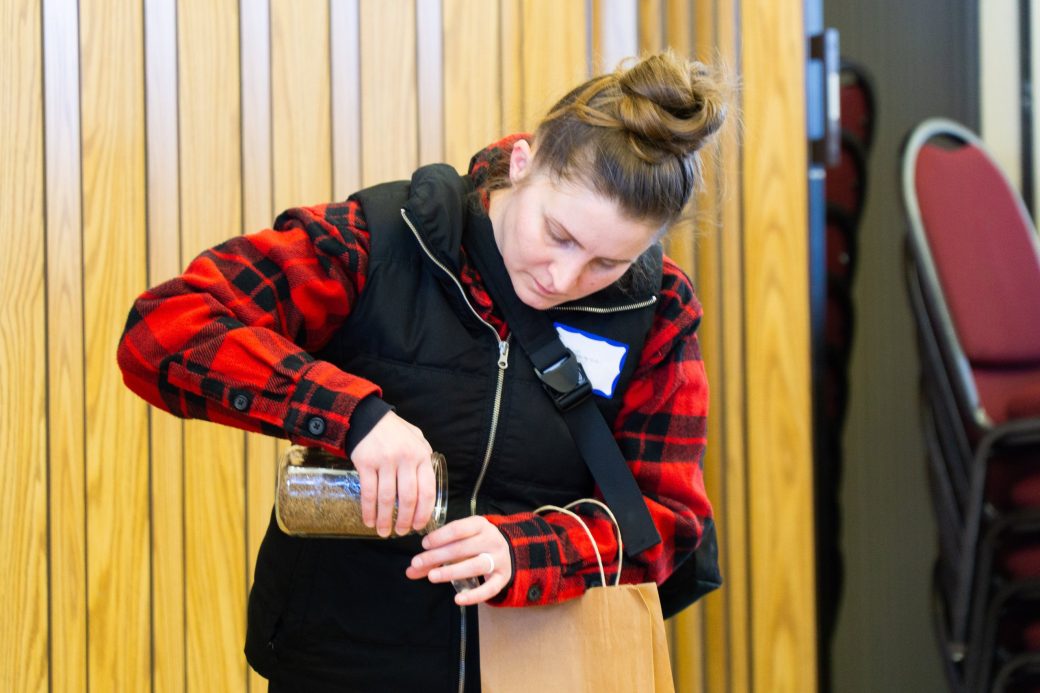 Woman putting seeds in a pack