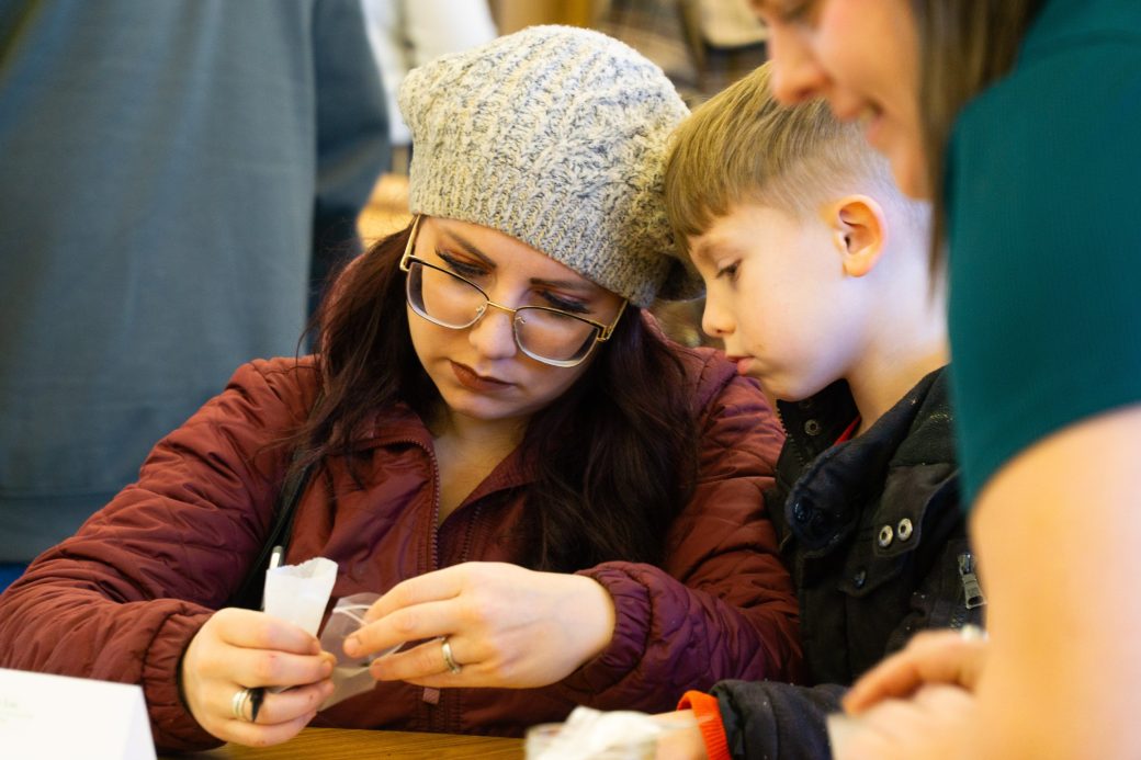 A woman and a kid looking in a seed pack