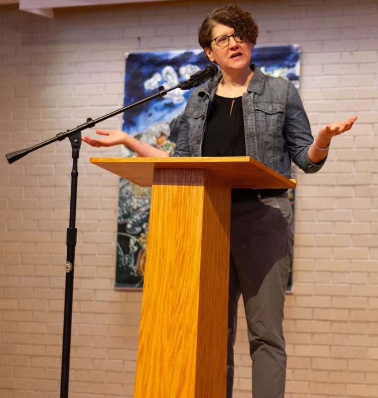 Woman doing a speech at stage's pulpit