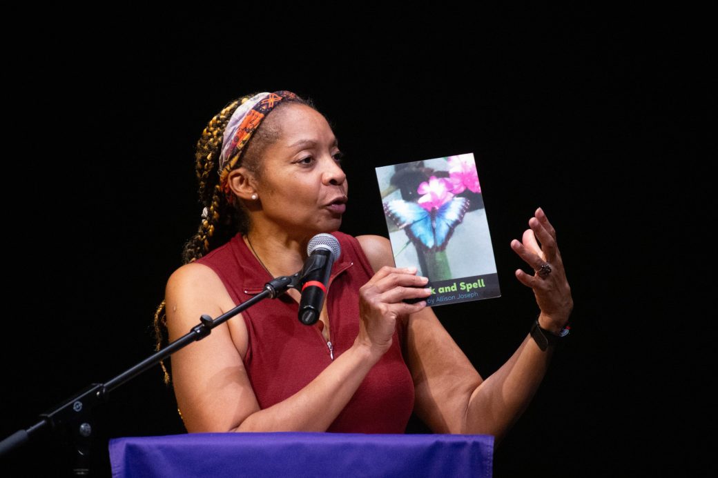 Woman with an image doing a speech at stage's pulpit at King Celebration 2024