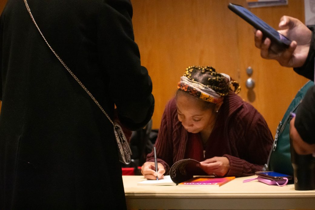 Woman writing in a paper at King Celebration 2024