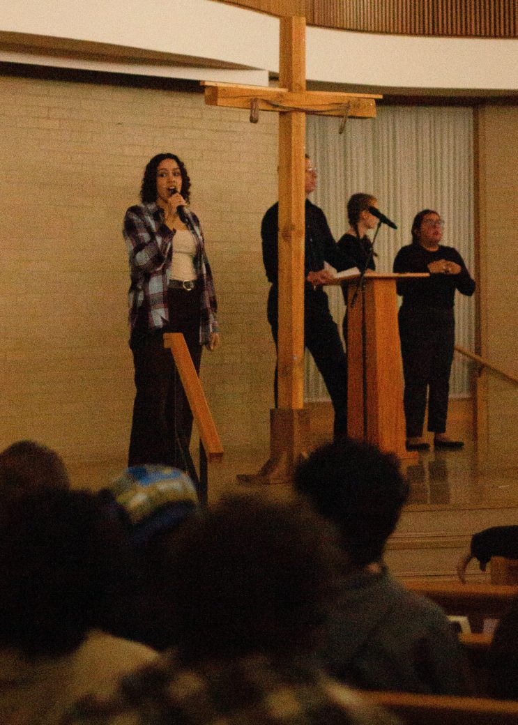 Woman doing a speeh at the stage's chapel