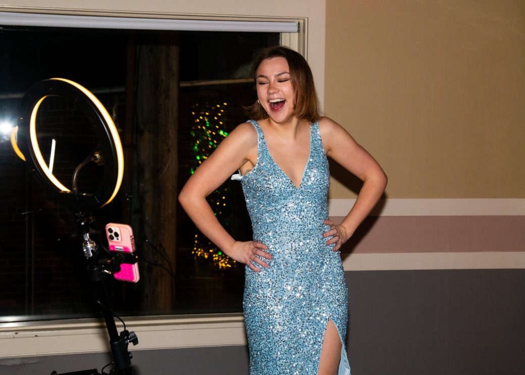 Woman with a dress smiling to her phone
