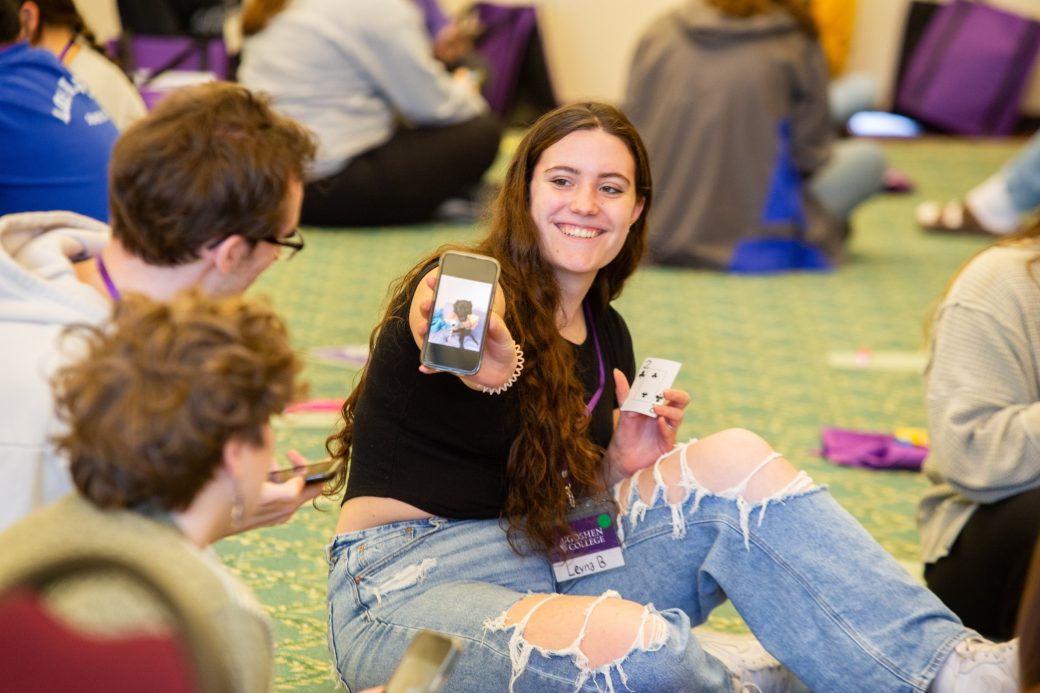 Woman showing a photo to a kid and a man