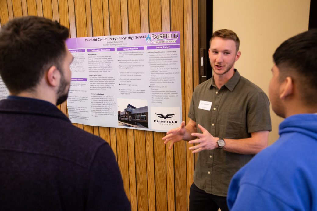 Two men talking at Academic Symposium 2024