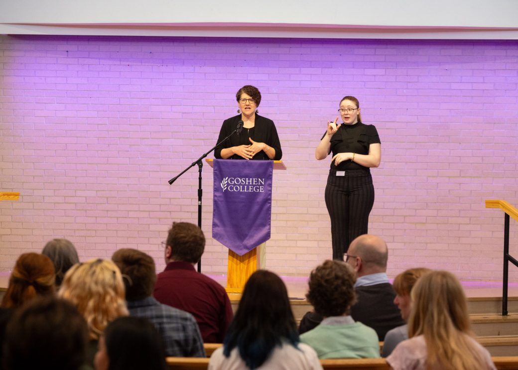 Woman giving a speech at Academic Symposium 2024