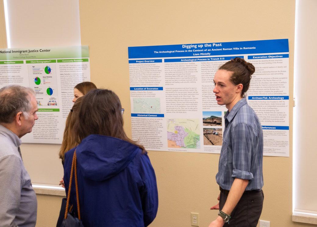 A man and a woman talking at Academic Symposium 2024