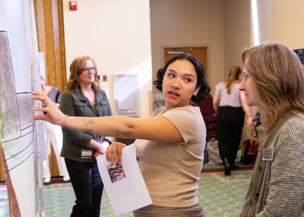 Two women talking at Academic Symposium 2024