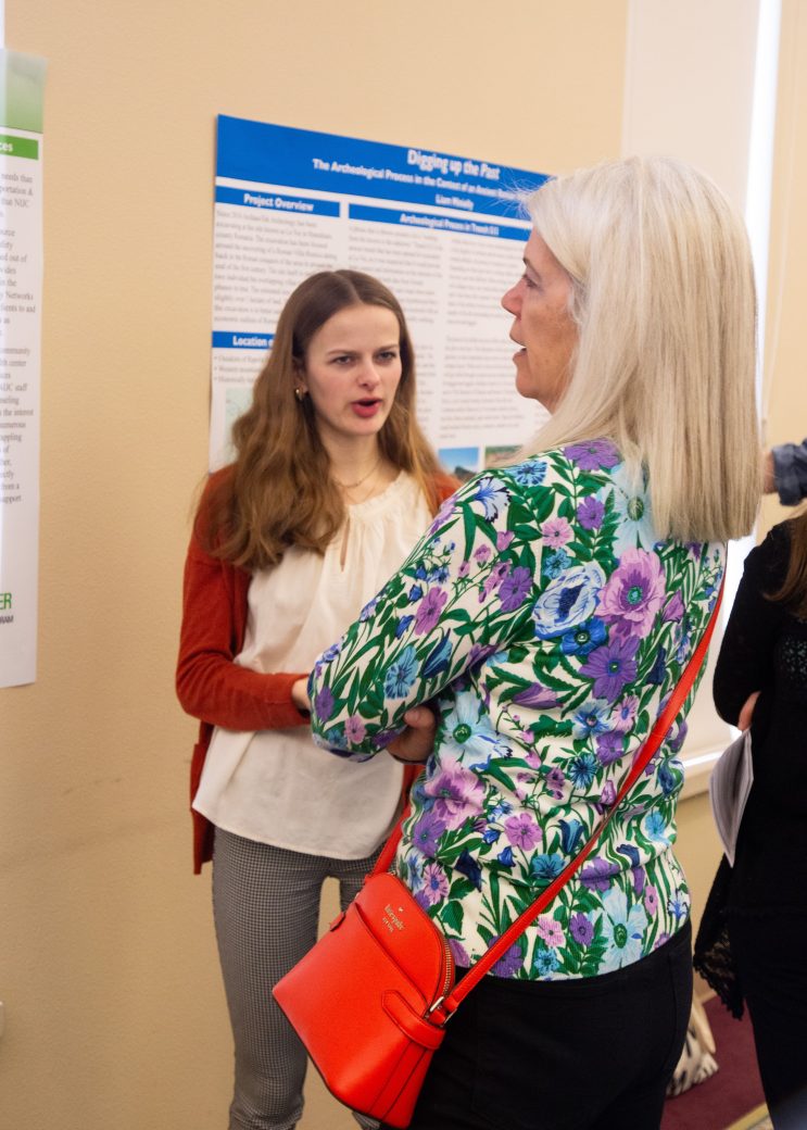 Two women talking at Academic Symposium 2024