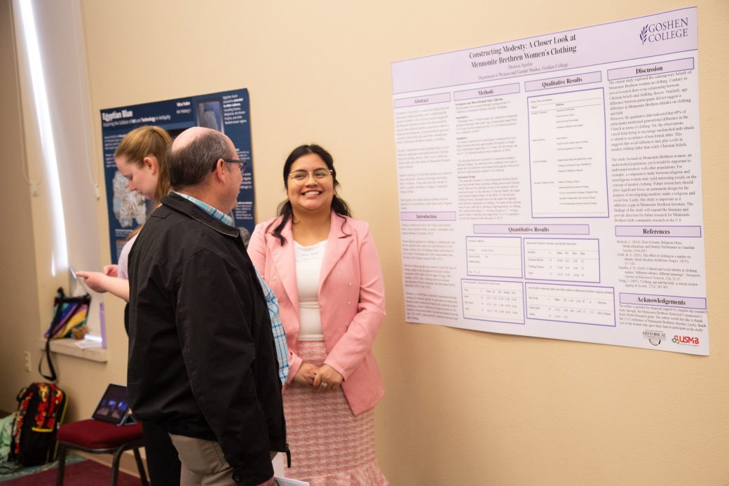 A man and a woman talking at Academic Symposium 2024