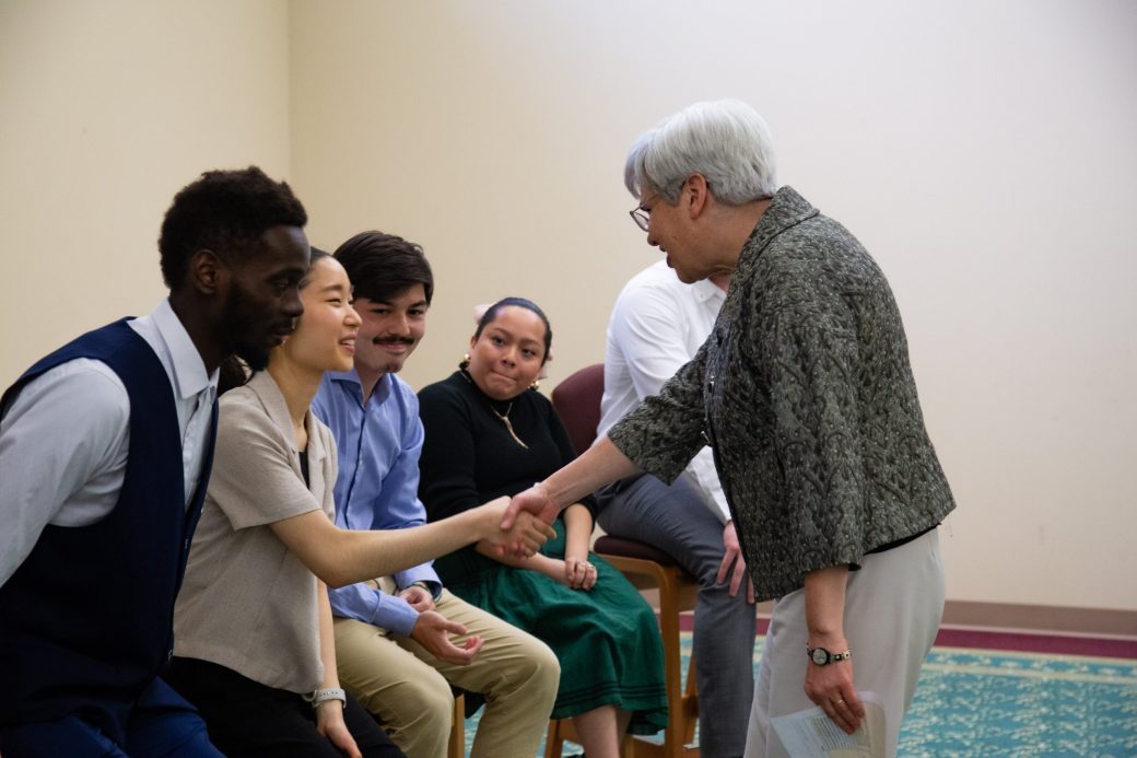 A man and a woman handshaking atPresident's Graduating Leaders Awards 2024