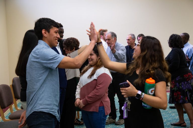 A man and a woman handshaking atPresident's Graduating Leaders Awards 2024