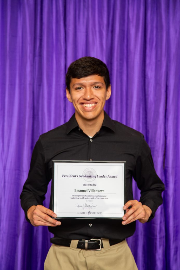 Man carrying certificate at President's Graduating Leaders Awards 2024
