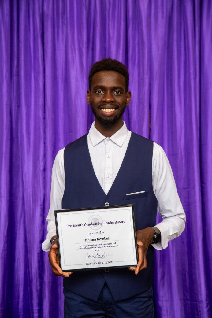 Man carrying certificate at President's Graduating Leaders Awards 2024
