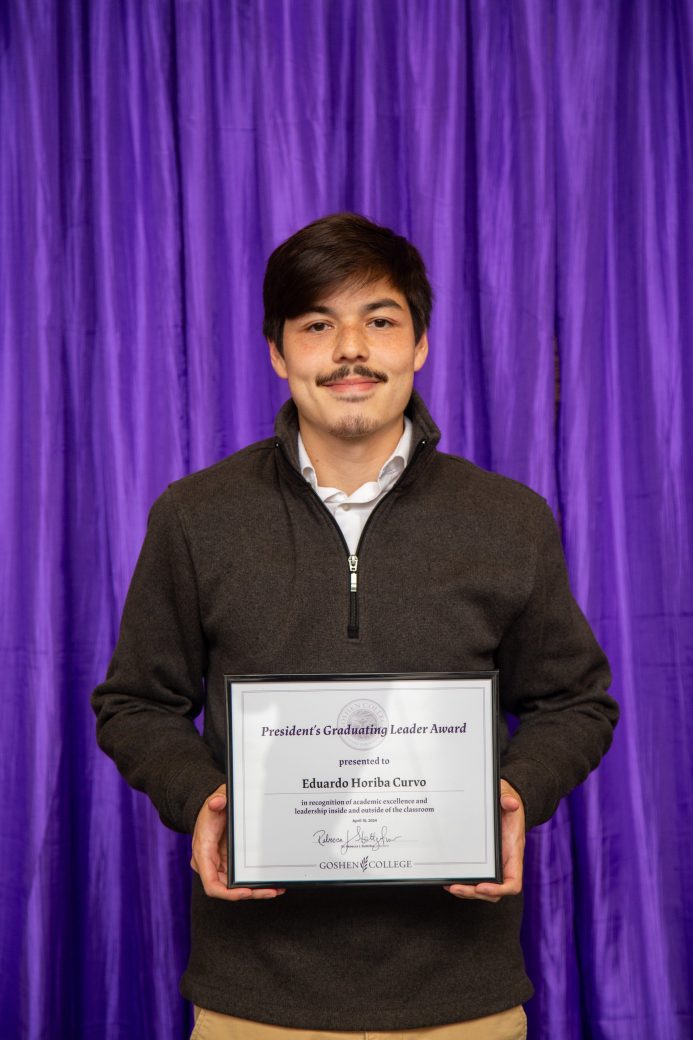 Man carrying certificate at President's Graduating Leaders Awards 2024