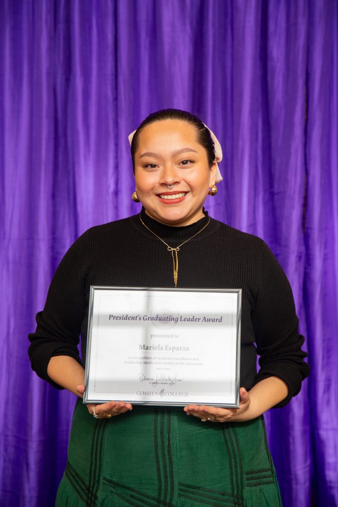woman carrying certificate at President's Graduating Leaders Awards 2024