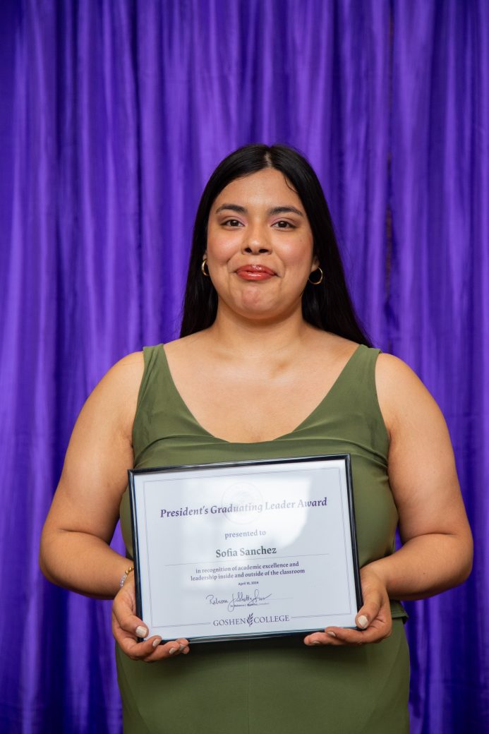 woman carrying certificate at President's Graduating Leaders Awards 2024