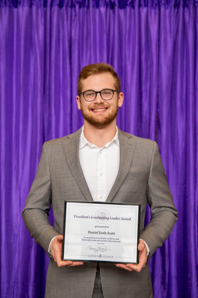 Man carrying certificate at President's Graduating Leaders Awards 2024
