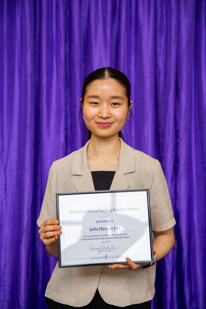 woman carrying certificate at President's Graduating Leaders Awards 2024