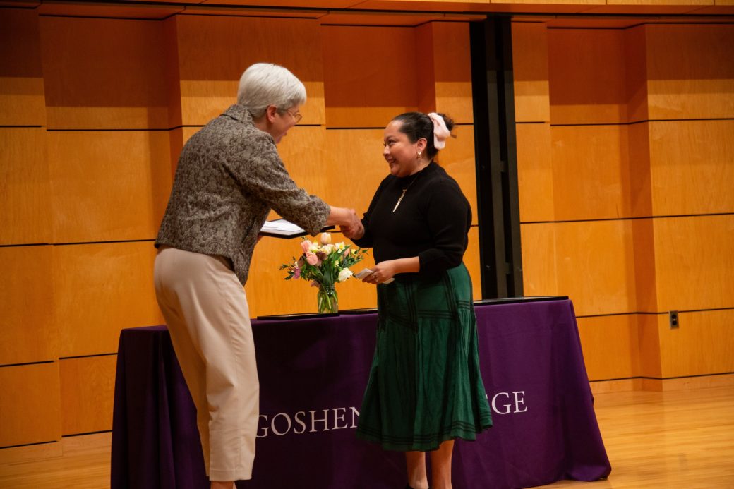 A man and a woman on the stage handshaking atPresident's Graduating Leaders Awards 2024