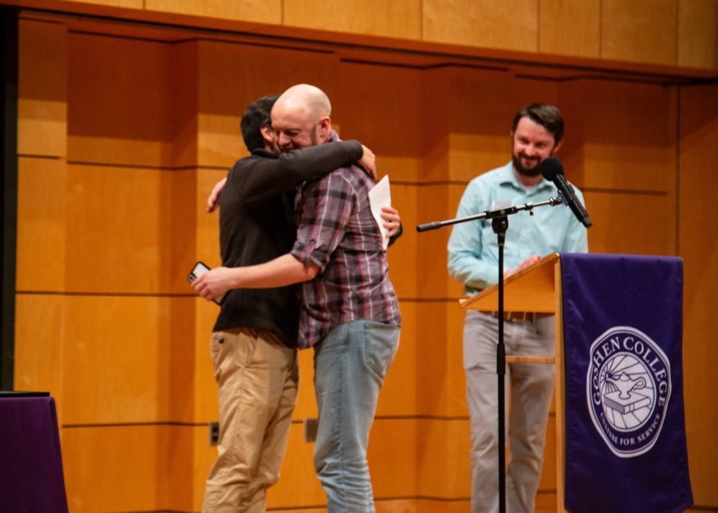 Two men hugging on the stage at President's Graduating Leaders Awards 2024