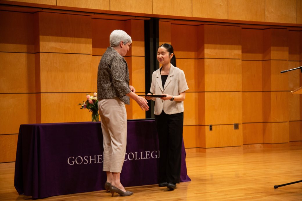 A man and a woman talking on the stage at President's Graduating Leaders Awards 2024
