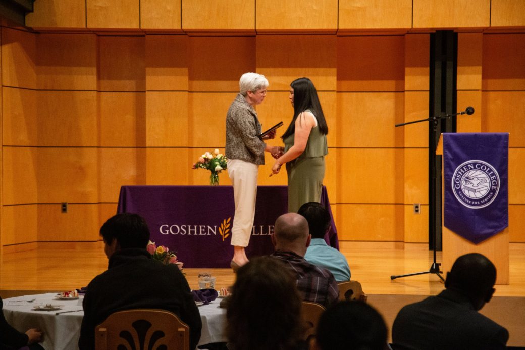 A man and a woman doing a handshake at President's Graduating Leaders Awards 2024