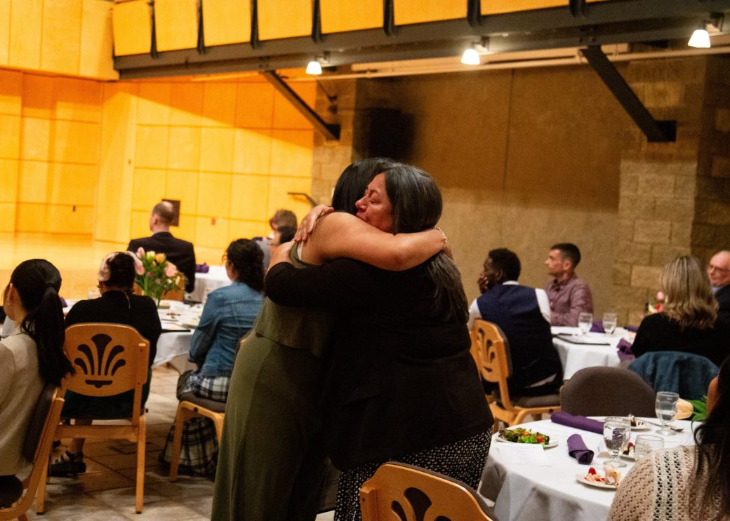 Peopl,e hugging at President's Graduating Leaders Awards 2024