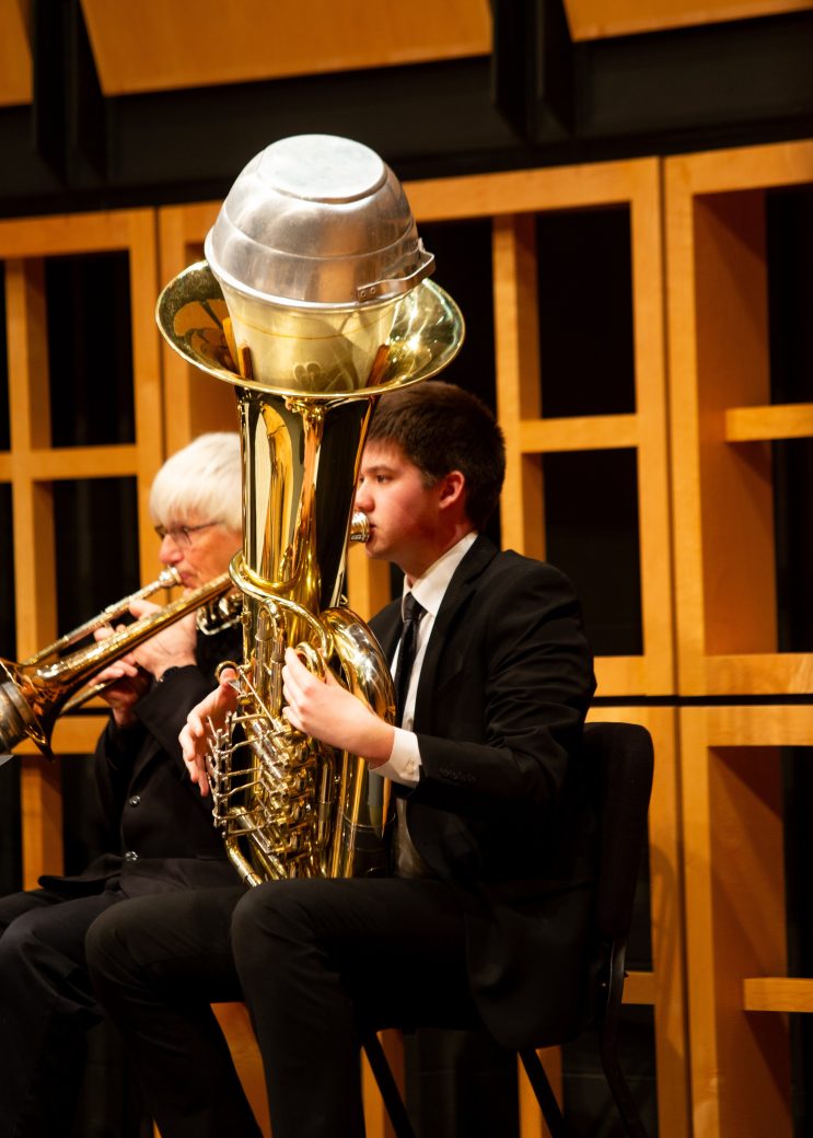 Man of the orchestra playing trumpet at GC Symphony Orchestra Spring Concert 2024
