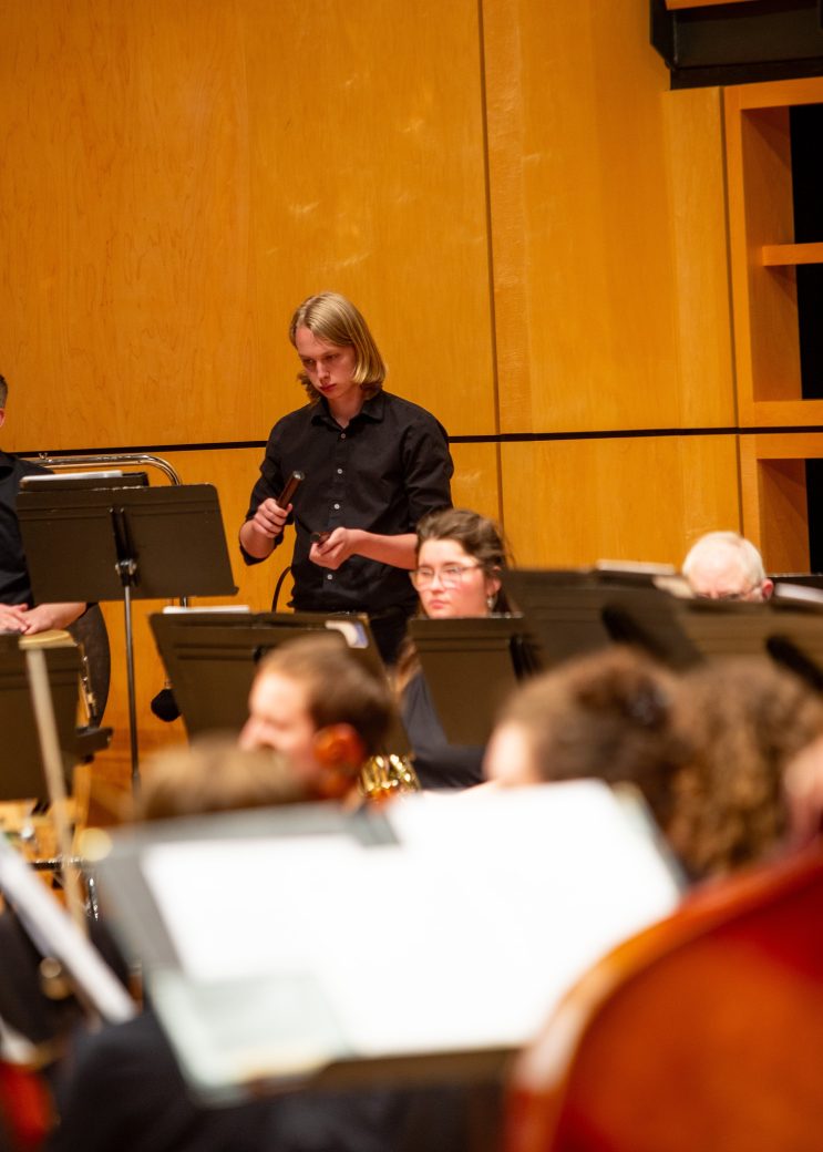 Orchestra's maestro conducting at GC Symphony Orchestra Spring Concert 2024