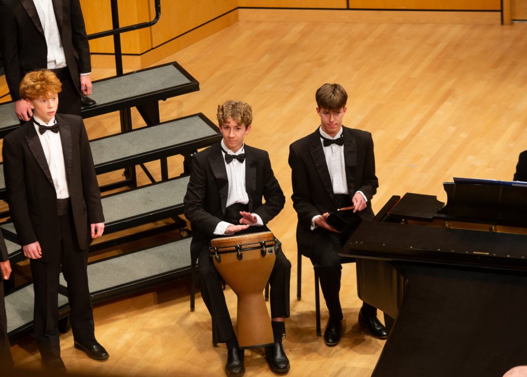 Members of the music choir singing and playing instruments