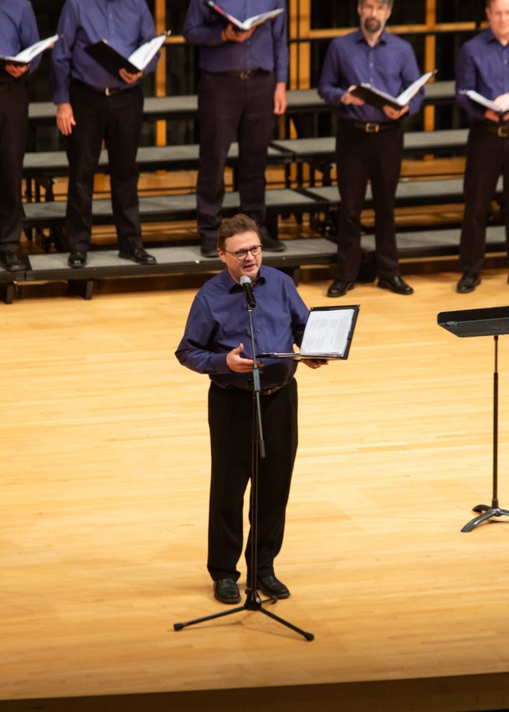 Man speaking on stage at low voice festival