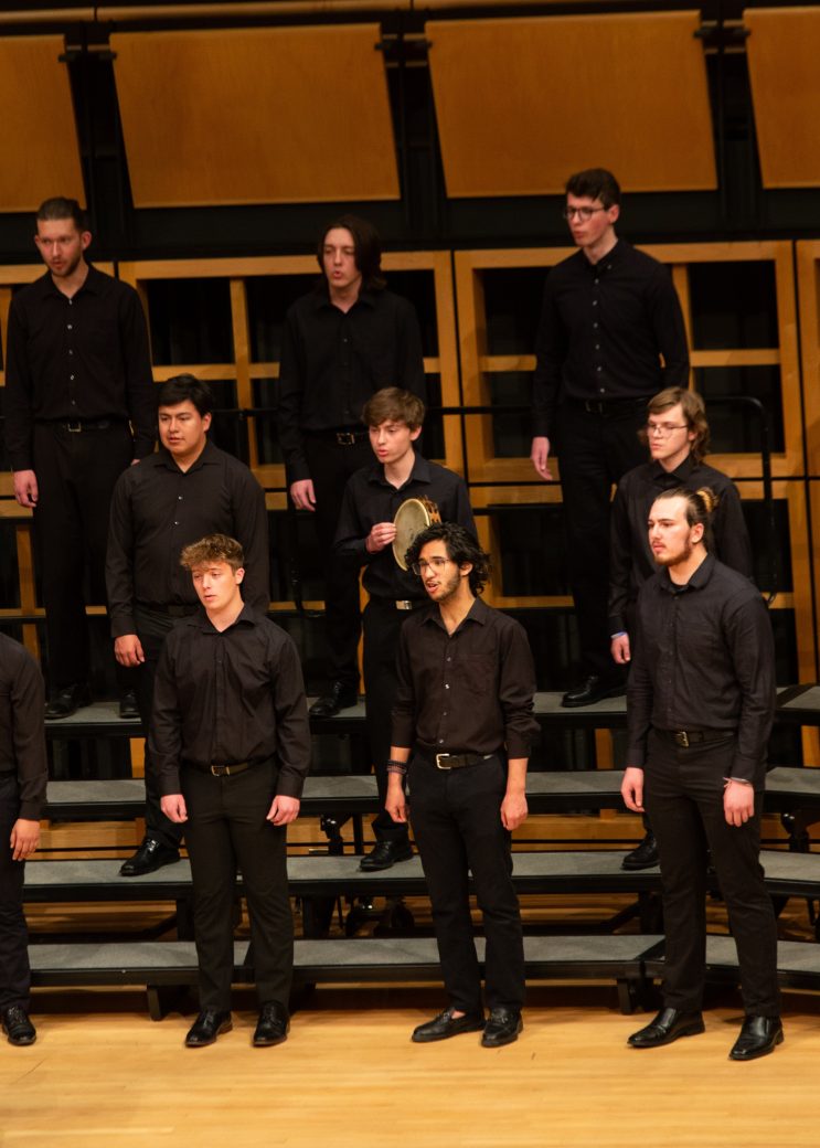 Members of music choir dressed with black clothes and singing