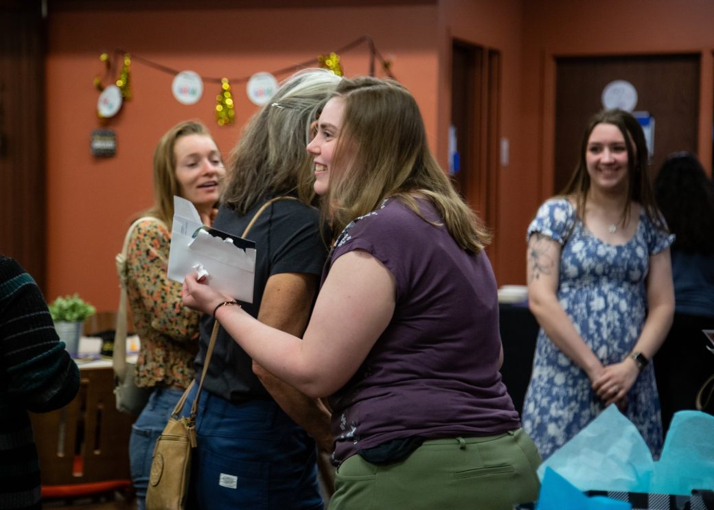 Two women hugging at Academic Department Receptions and Baccalaureate Celebration