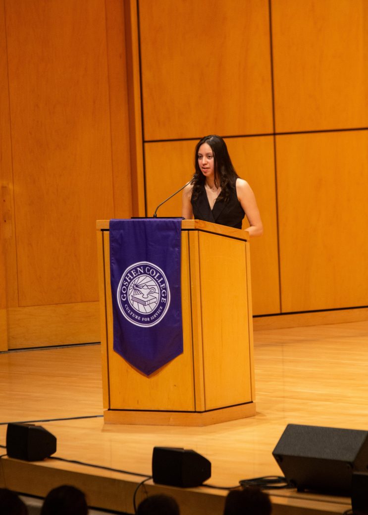 Woman doing a speech at the stage's pulpit
