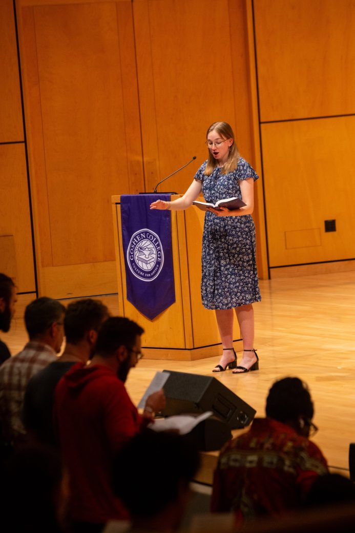 Woman doing a speech at the stage's pulpit