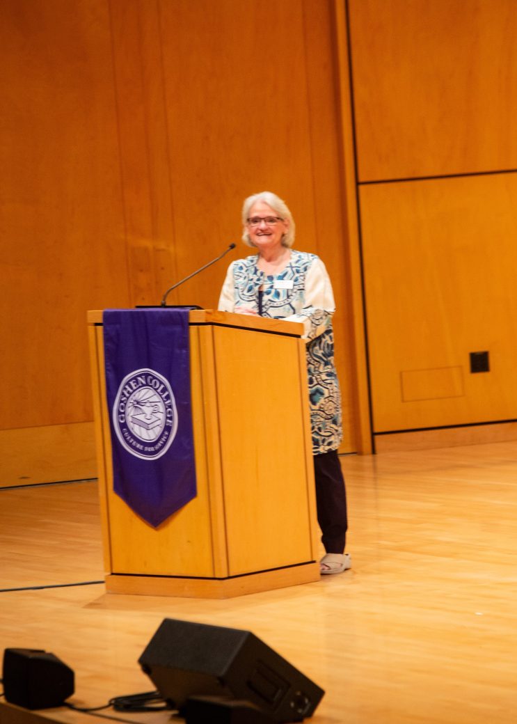 Woman doing a speech at the stage's pulpit