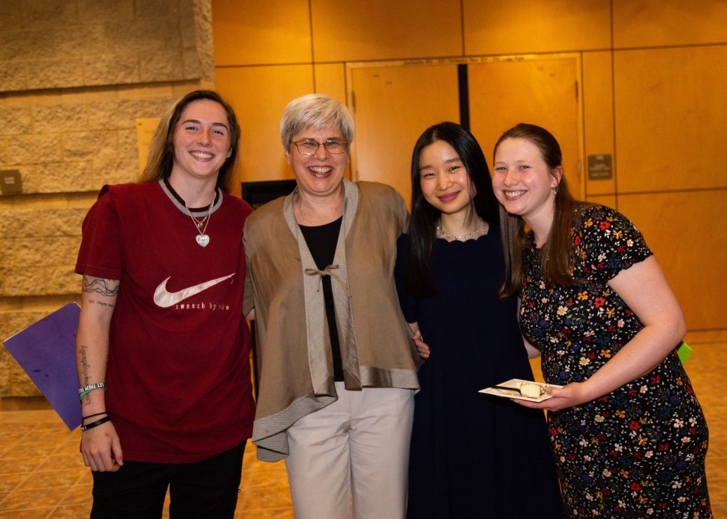 Four women hugging at Academic Department Receptions and Baccalaureate Celebration