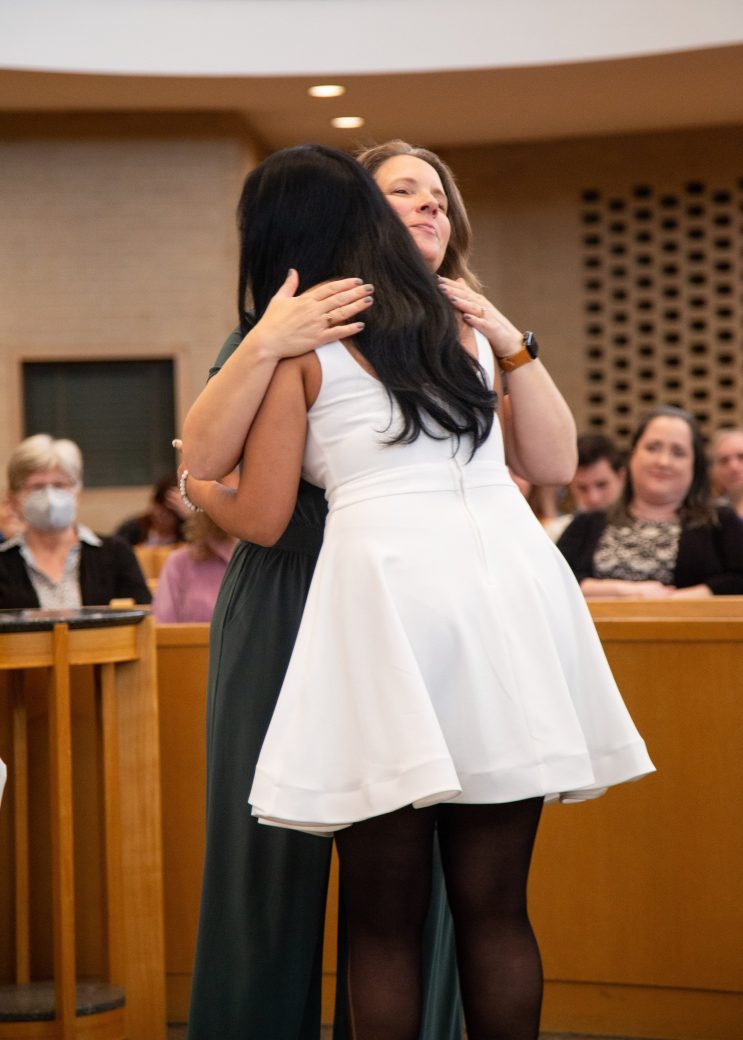 Two women hugging at Commencement 2024: Nurses' Pinning Ceremony