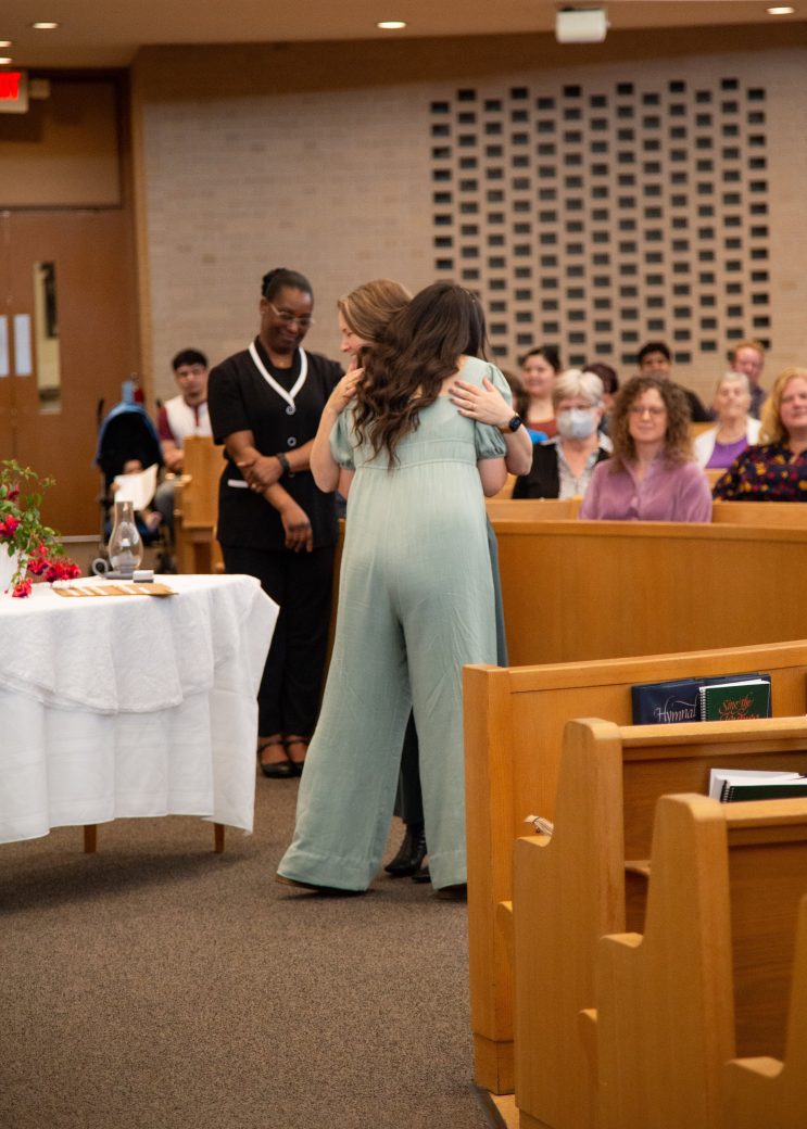Two women hugging at Commencement 2024: Nurses' Pinning Ceremony