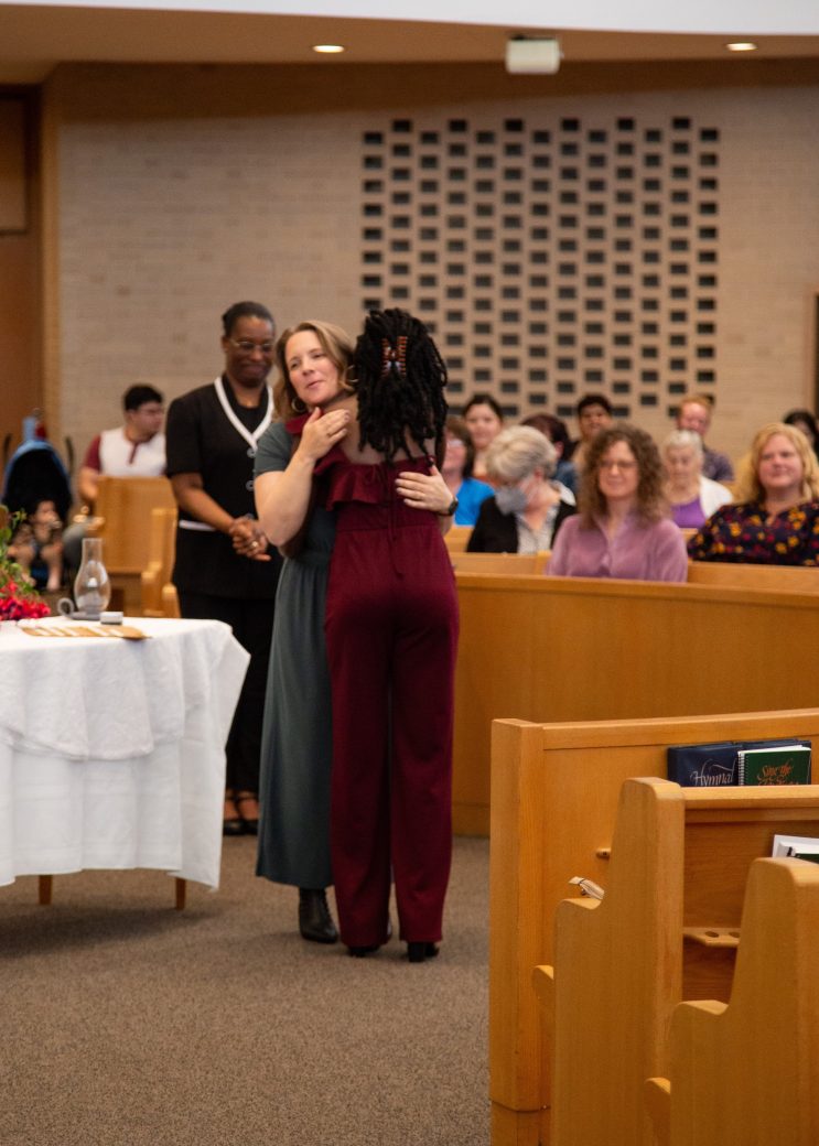 Woman putting a pin at Commencement 2024: Nurses' Pinning Ceremony