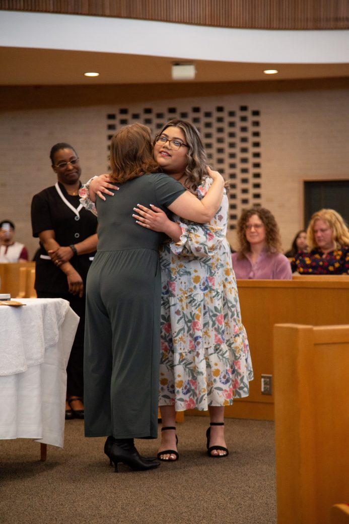 Two women hugging at Commencement 2024: Nurses' Pinning Ceremony