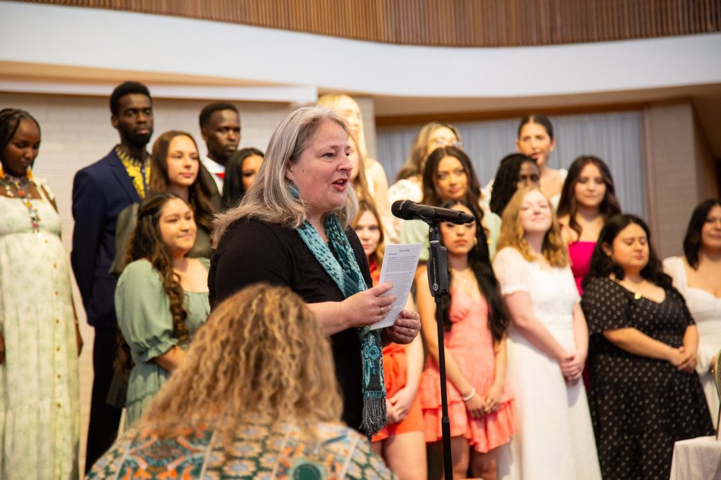Woman doing a speech at Commencement 2024: Nurses' Pinning Ceremony