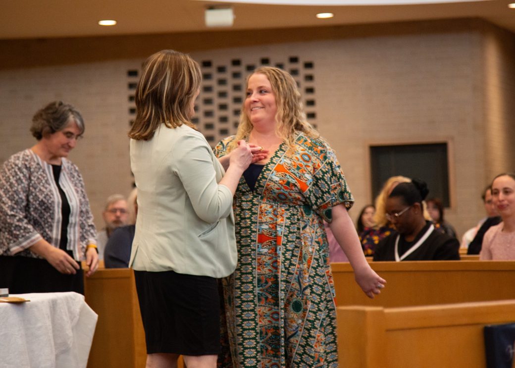 Woman pinning other woman at Commencement 2024: Nurses' Pinning Ceremony