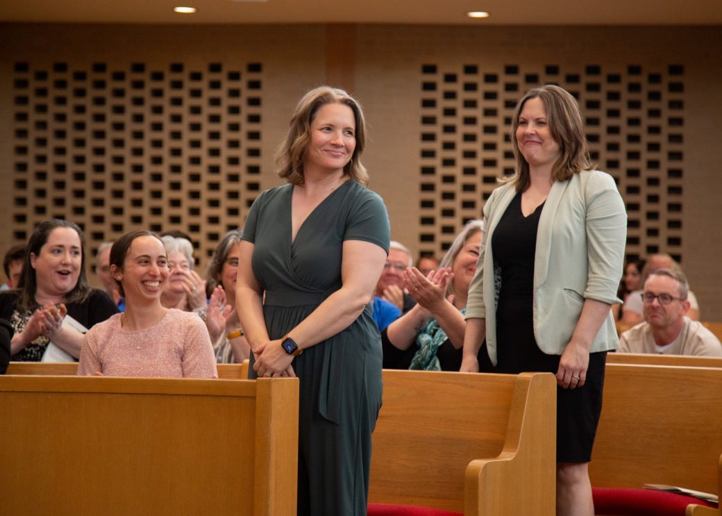 Two women standed up at Commencement 2024: Nurses' Pinning Ceremony