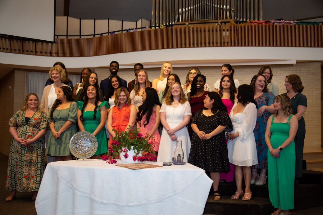 Pins nurses smiling to the camera at Commencement 2024: Nurses' Pinning Ceremony