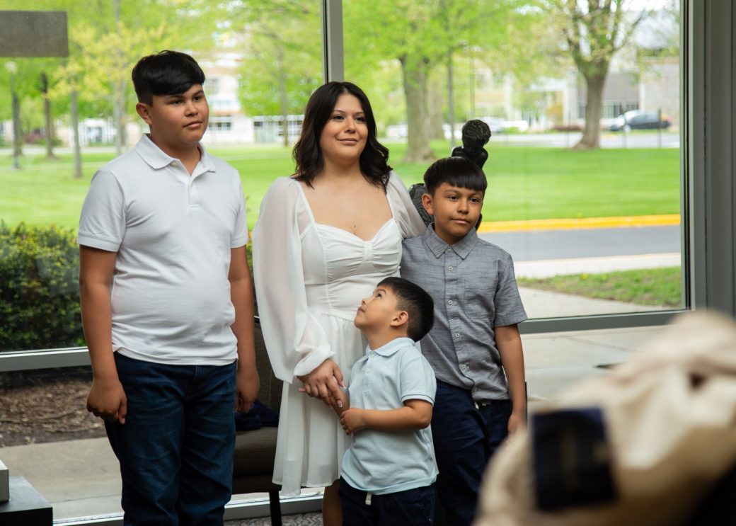 A family smiling to the camera at Commencement 2024: Nurses' Pinning CeremonyCommencement 2024: Nurses' Pinning Ceremony
